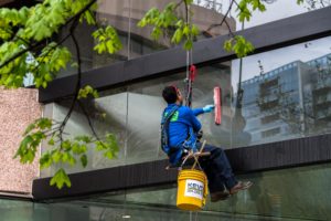 repelling down the building cleaning windows
