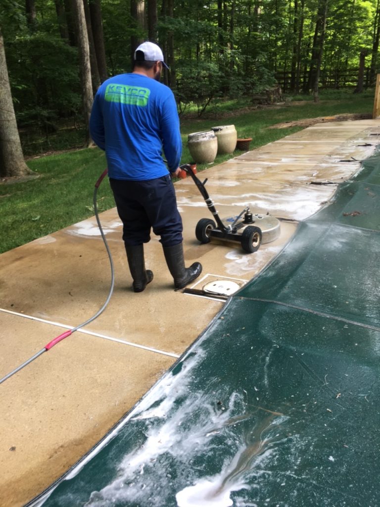 sidewalk cleaning by an inground swimming pool