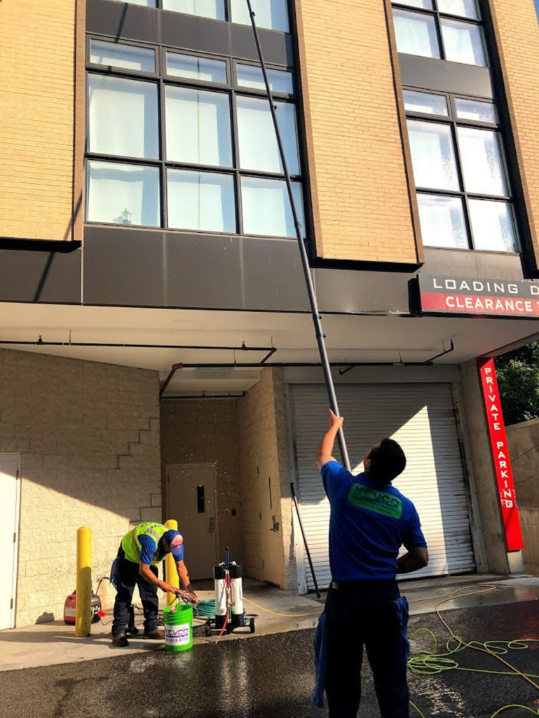 kevco employees cleaning commercial windows from the ground