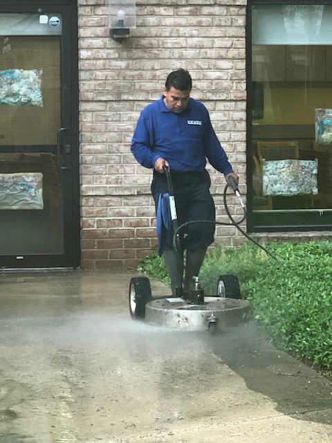 kevco employee cleaning sidewalks